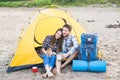 People, tourism and nature concept - Couple having fun on camping trip with cat Royalty Free Stock Photo