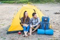 People, tourism and nature concept - Couple having fun on camping trip with cat Royalty Free Stock Photo