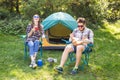 People, tourism and nature concept - Couple having fun on camping trip Royalty Free Stock Photo