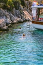 Tourists swim by enjoying the deep blue waters in Yaglica Cove of Kekova.