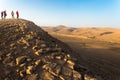 People standing desert mountain peak, south Israel arid landscape