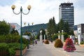 People in town centre enjoy nice day, high Administrative building of state agencies in background