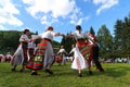 People in traditional authentic folklore costume a meadow near Vratsa, Bulgaria