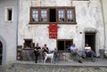 People in traditional cafe in the swiss village Gruyeres, Switzerland.