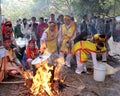 People in traditional costume exam to make round sticky rice cake