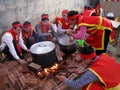 People in traditional costume exam to make round sticky rice cake