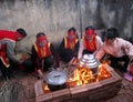 People in traditional costume exam to make round sticky rice cake