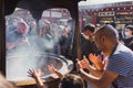 People at a traditional Jokoro at Senso-Ji Temple, Tokyo, Japan