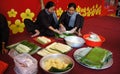 People with traditional Vietnamese dress making traditional food