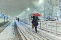 People in traffic through snow in Bucharest, Romania