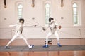 People, training with sword and fight in fencing competition, duel or combat with martial arts fighter and athlete with Royalty Free Stock Photo