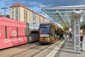 People at a tram stop in the city center of Dresden