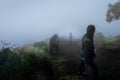 People Travel Hiking up to Mountain on Misty Weather