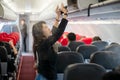 People traveler and tourism woman open overhead locker on airplane and airport for travel trip in summer and holiday time.