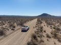 People traveling by car in the desert and driving on scenic empty road. Royalty Free Stock Photo