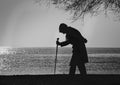 People and Trees, Elderly woman walking on a cane Royalty Free Stock Photo