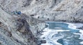 People trekking on frozen zanskar river. Camping tents on top of mountain. Chadar trek. Ladakh. India