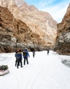 People trekking on frozen zanskar river. Trekkers pulling bags on ice. Chadar trek, Ladakh. India. Royalty Free Stock Photo
