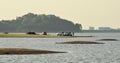 People with truck travel and relax at reservoir