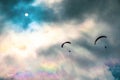 People try paragliding flying with parachutes against clouds Royalty Free Stock Photo