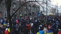 People with Ukrainian symbolics form huge crowd in a narrow street, revolution