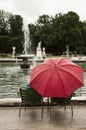 People with umbrella by rainy day in tuilerie garden