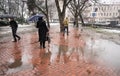 People with umbrella walking down the street on rainy day. Intentional motion blur