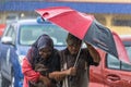 People under heavy monsoon rain