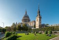 People under the sun in a garden next to Saint Paul`s Cathedral at sunset in London Royalty Free Stock Photo