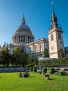 People under the sun in a garden next to Saint Paul`s Cathedral at sunset Royalty Free Stock Photo