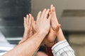 People uniting hands together in cooperation gesture