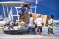 People unloading of the goods from speed wooden boat to Gili AIr, paradise island in Indonesia