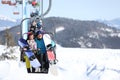 People using chairlift at mountain ski resort. Winter vacation Royalty Free Stock Photo