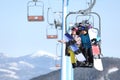 People using chairlift at mountain ski resort. Winter vacation Royalty Free Stock Photo