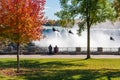 People using the Niagara Falls Zipline ride attraction. Niagara Falls City Red maple leaf during autumn foliage Royalty Free Stock Photo