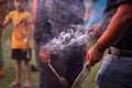 People using perforated plates to collect coals, cow dung cakes, roasted wheat gram on holi lohri