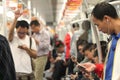 People using phones in the metro