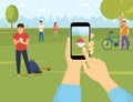 People using smartphones to catch pokemons in the park