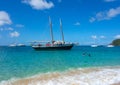 A wooden schooner anchored off a pristine beach on christmas day