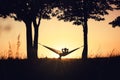 People on vacation. A girl`s silhouette in a hammock between trees. A hammock in the background of the sunset. Royalty Free Stock Photo