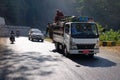 People and vehicles on mountain road in Inle, Myanmar