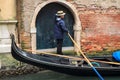 People in Venice, Italy. Gondolier in gondola carries tourists to famous place