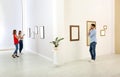 People viewing exposition in art gallery