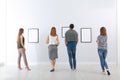 People viewing exposition in art gallery