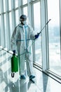 People in virus protective suits and mask disinfecting buildings of coronavirus with the sprayer Royalty Free Stock Photo