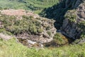 People are visible next to Gudu River above Gudu Falls Royalty Free Stock Photo