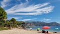 People visit beautiful summer sandy beach in France.
