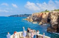 People visit Boca do Inferno, famous attraction in the coast of Cascais, Portugal. Hell`s Mouth is touristic Royalty Free Stock Photo