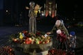 People visit a monument to Holodomor big hunger victims during a commemoration ceremony in Kyiv, Ukraine