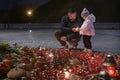 People visit a monument to Holodomor big hunger victims during a commemoration ceremony in Kyiv, Ukraine